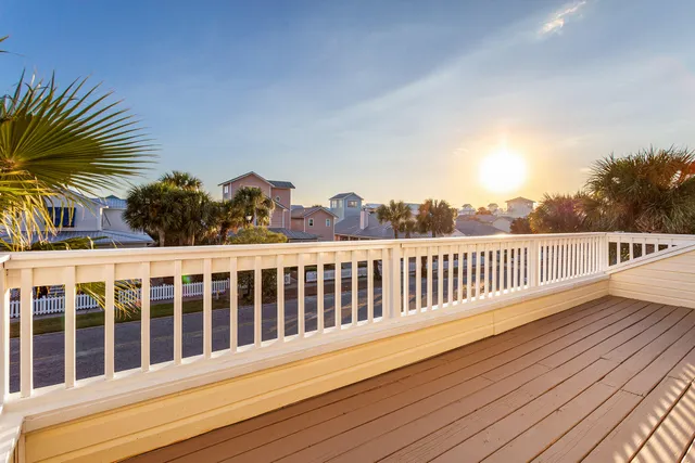 a view of balcony with wooden floor and fence
