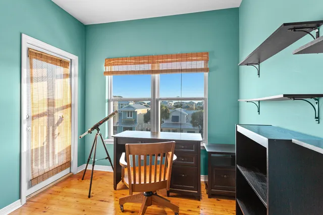a view of a room with furniture wooden floor and windows