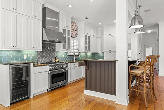 a kitchen with stainless steel appliances kitchen island granite countertop a stove a sink and a microwave