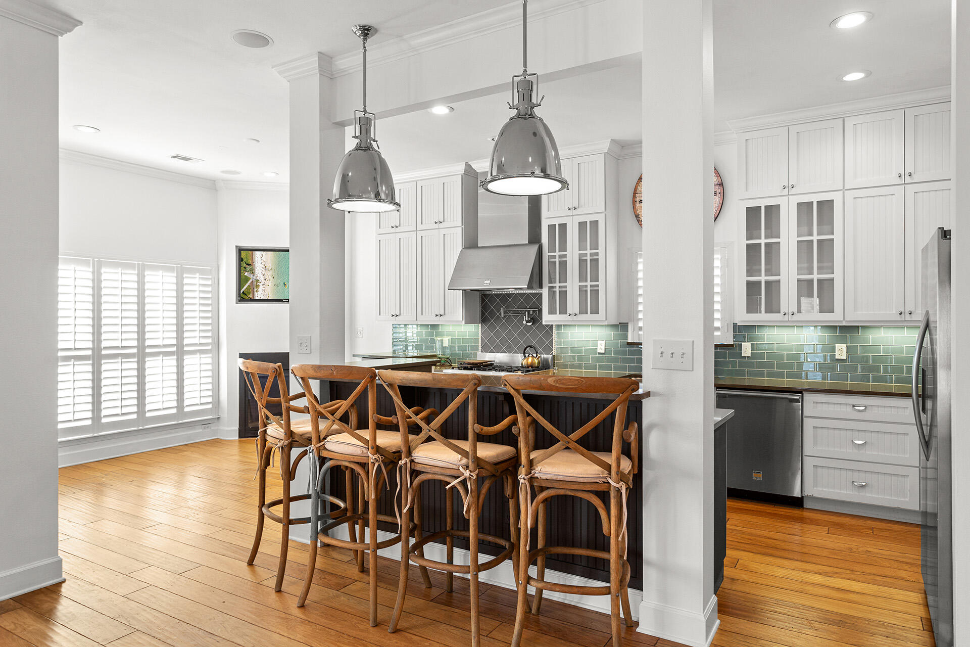 4460 Clipper Cove Destin, FL 32541 - Photo 10 of 37 a view of a kitchen with granite countertop a dining table chairs cabinets and wooden floor