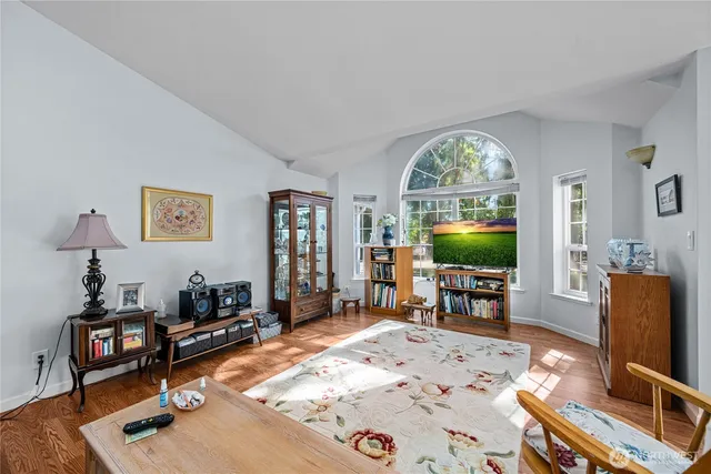 a living room with furniture a window and a flat screen tv
