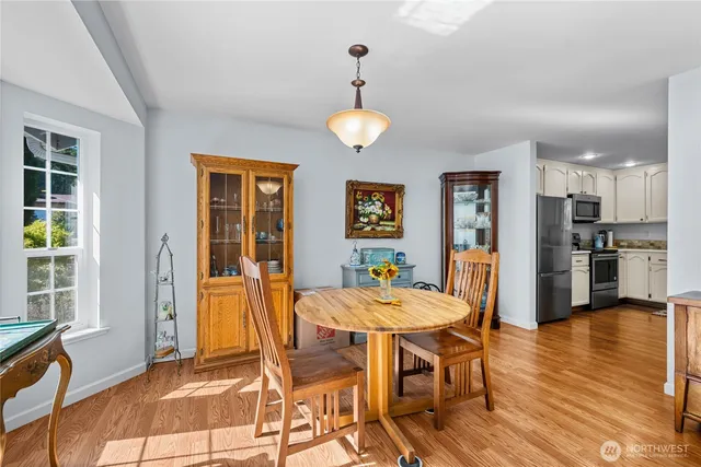 a view of a dining room with furniture and wooden floor