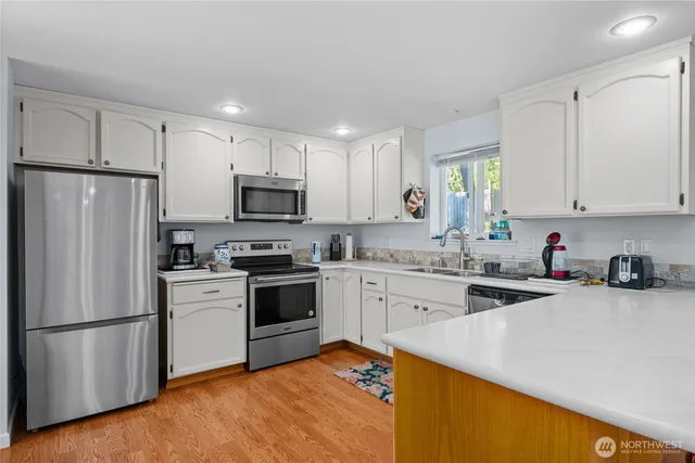 a kitchen with a sink a stove a refrigerator and a sink