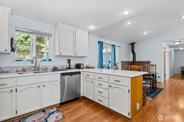a kitchen with granite countertop a sink cabinets and window
