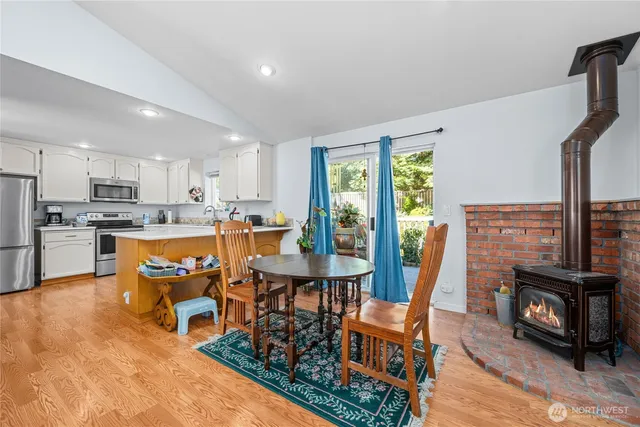 a living room with furniture and a flat screen tv with kitchen view