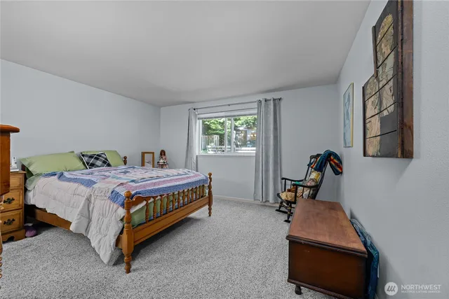 a bed room with a bed and a chair