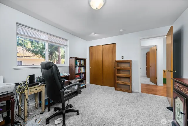 a view of a workspace with furniture and a window