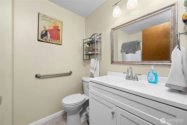 a bathroom with a toilet sink and mirror