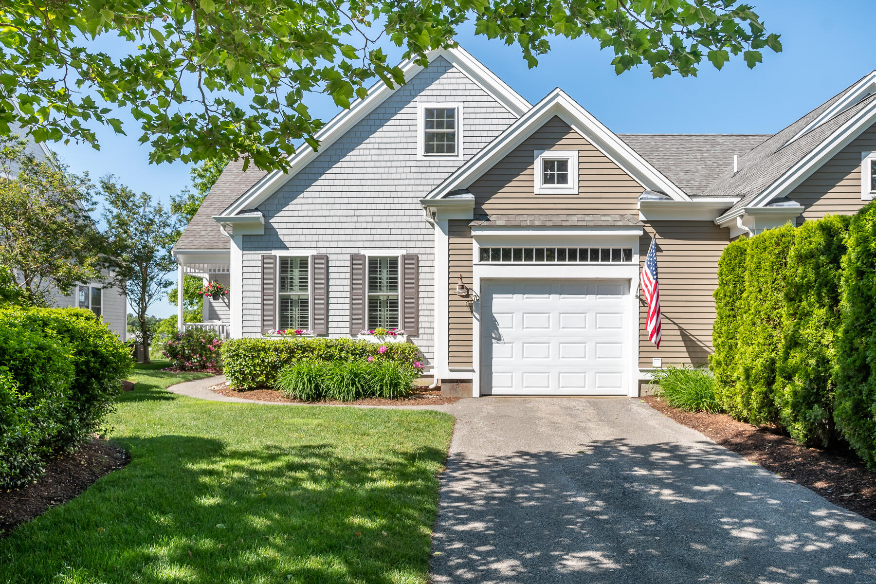 a front view of a house with a yard and garage