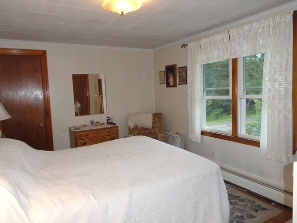 431 Spring Street Hanson, MA 02341 - Photo 11 of 21 a bedroom with a bed and a large window