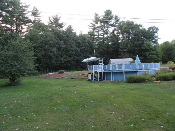 431 Spring Street Hanson, MA 02341 - Photo 13 of 21 a view of a house with a yard and sitting area