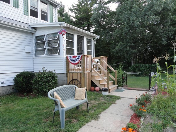 431 Spring Street Hanson, MA 02341 - Photo 3 of 21 a front view of a house with garden and trees