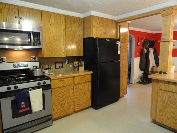 431 Spring Street Hanson, MA 02341 - Photo 4 of 21 a kitchen with a refrigerator and a stove