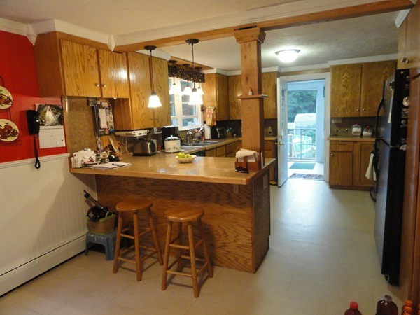 431 Spring Street Hanson, MA 02341 - Photo 6 of 21 a dining table with chairs and a refrigerator