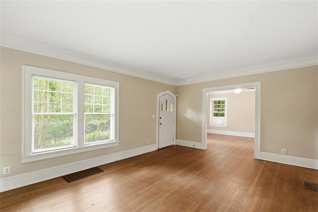 1424 Emory Road Northeast Atlanta, GA 30306 - Photo 9 of 36 an empty room with wooden floor and windows
