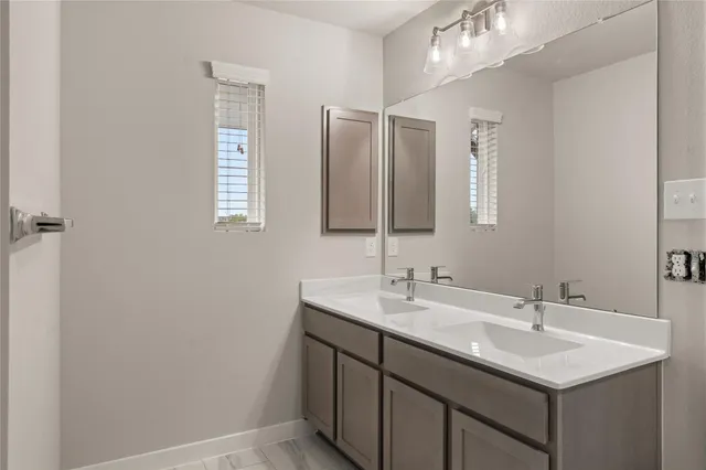 a bathroom with a sink double vanity and a mirror