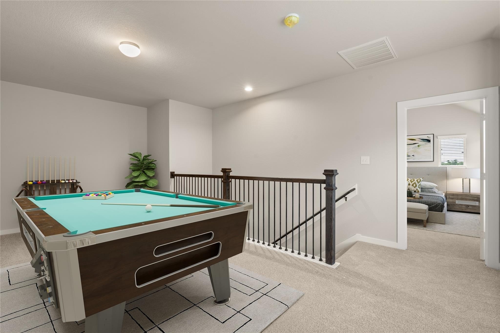 2639 Finley Lane Rosenberg, TX 77471 - Photo 9 of 18 This cozy game room features a pool table and neutral tones, with carpeted flooring and a railing overlooking the staircase. A doorway opens to a well-lit adjacent room, enhancing the spacious feel.