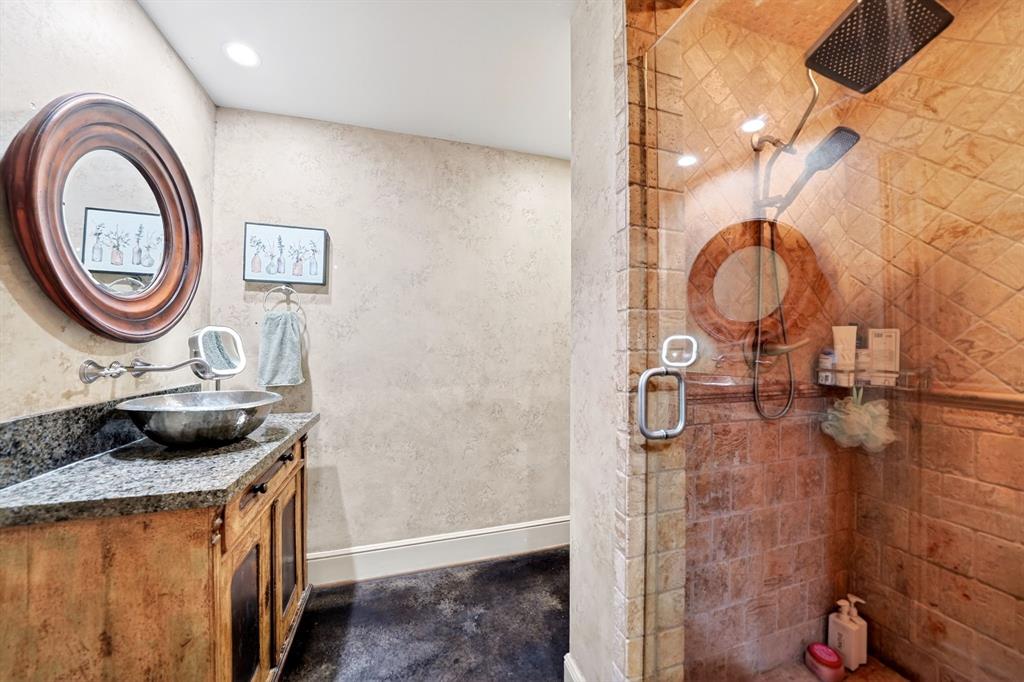 5055 Addison Circle, Unit 426 Addison, TX 75001 - Photo 22 of 38 a bathroom with a granite countertop shower a sink and a stove