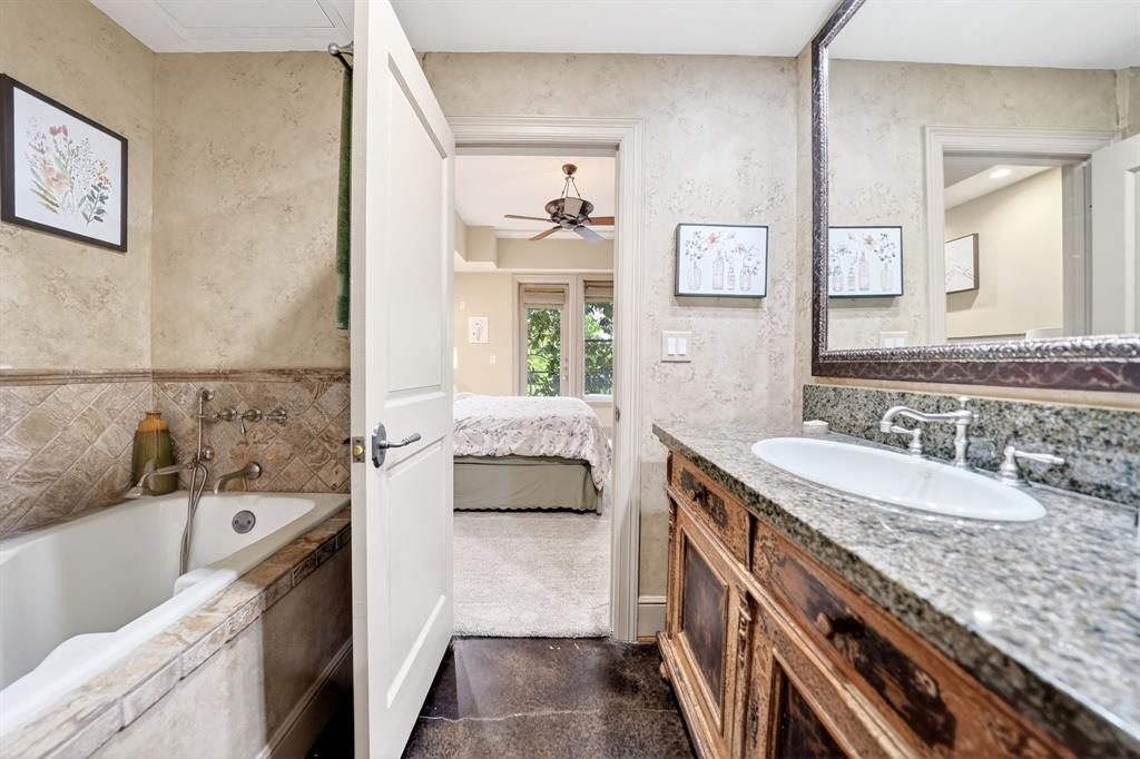 5055 Addison Circle, Unit 426 Addison, TX 75001 - Photo 23 of 38 a bathroom with a granite countertop tub sink and mirror