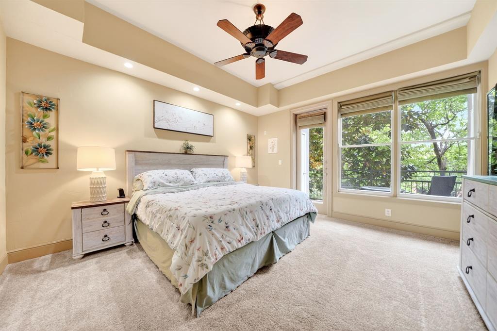 5055 Addison Circle, Unit 426 Addison, TX 75001 - Photo 25 of 38 a spacious bedroom with a large bed and a chandelier fan