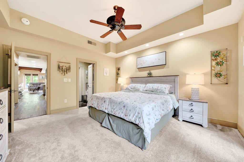 5055 Addison Circle, Unit 426 Addison, TX 75001 - Photo 26 of 38 a bedroom with a bed and a chandelier