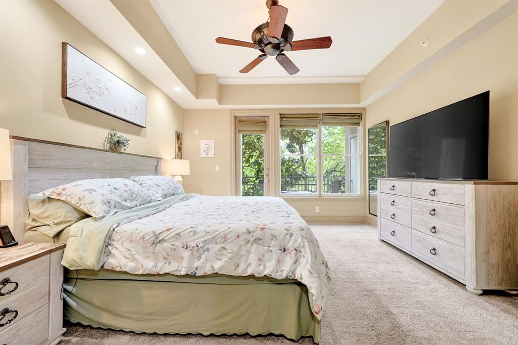 5055 Addison Circle, Unit 426 Addison, TX 75001 - Photo 27 of 38 a bedroom with a bed and flat screen tv