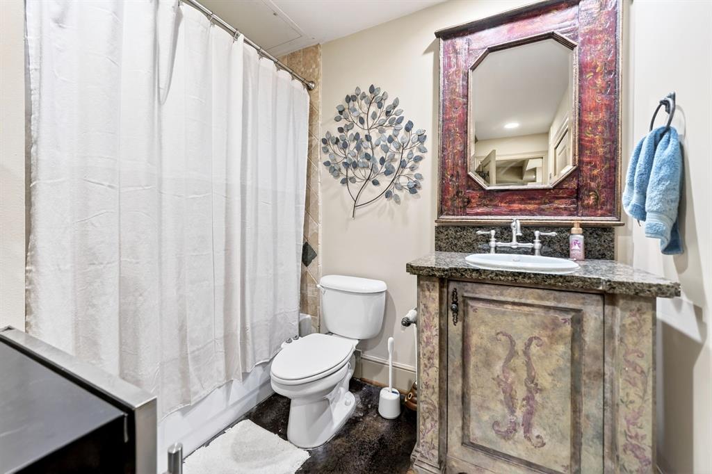 5055 Addison Circle, Unit 426 Addison, TX 75001 - Photo 31 of 38 a bathroom with a toilet a sink and a mirror