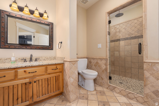 687 South 2080th Street East Springville, UT 84663 - Photo 35 of 149 Bathroom featuring a walk-in shower with glass enclosure, textured tile walls, and a pebble-style floor