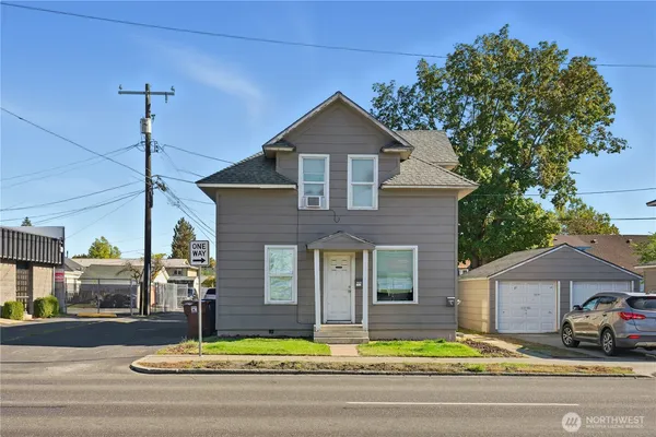 a front view of a house with a yard table and chairs