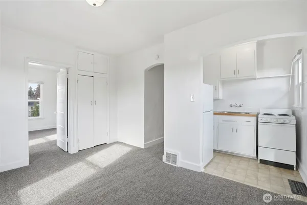 a view of a kitchen with white cabinets