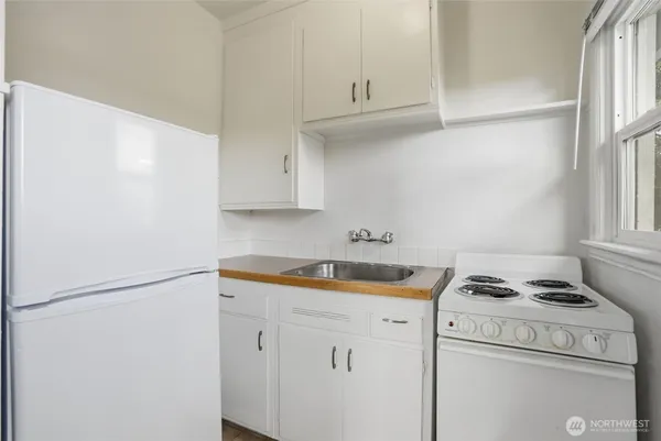 a kitchen with cabinets and a stove top oven