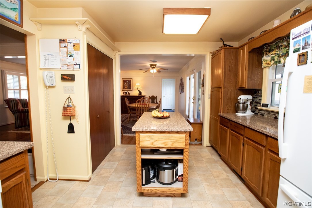 3384 Rice Creek Road Farmville, VA 23901 - Photo 15 of 50 a kitchen with stainless steel appliances granite countertop a refrigerator a stove and a sink with wooden floor