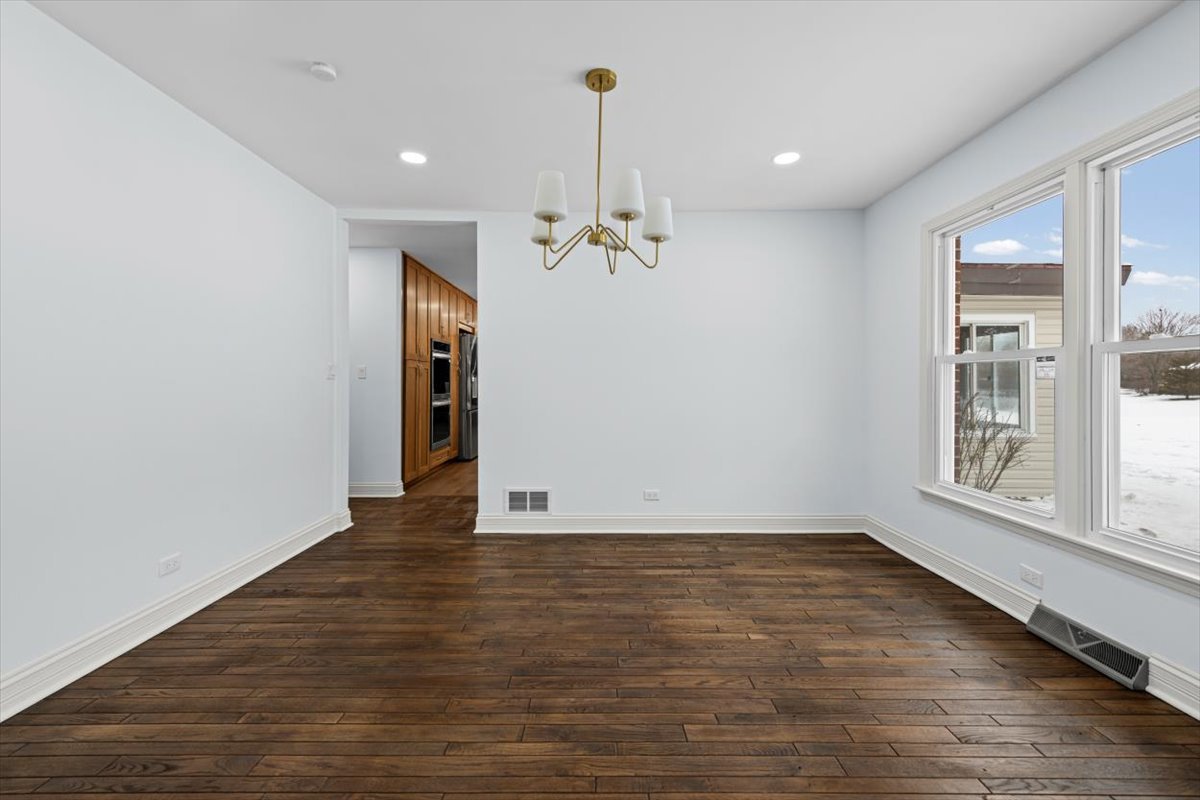 2527 Checker Road Long Grove, IL 60047 - Photo 11 of 32 wooden floor in an empty room with a window