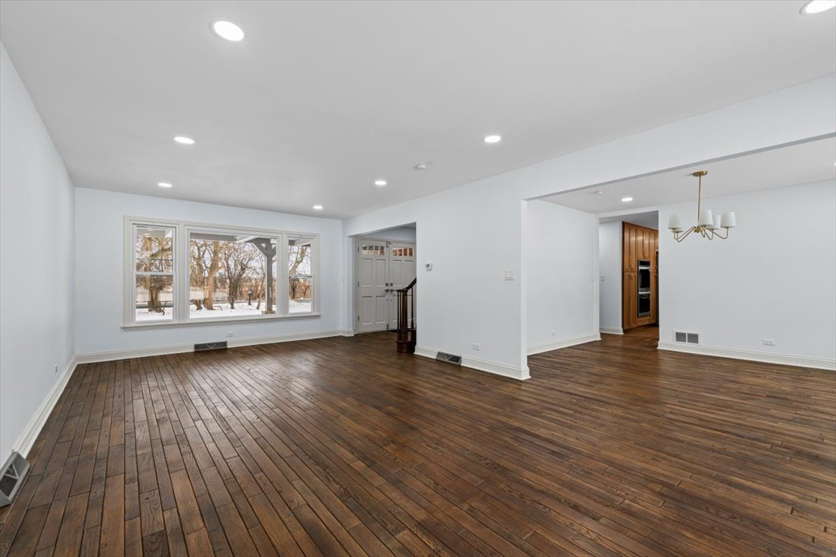 2527 Checker Road Long Grove, IL 60047 - Photo 14 of 32 a view of an empty room with wooden floor and a window
