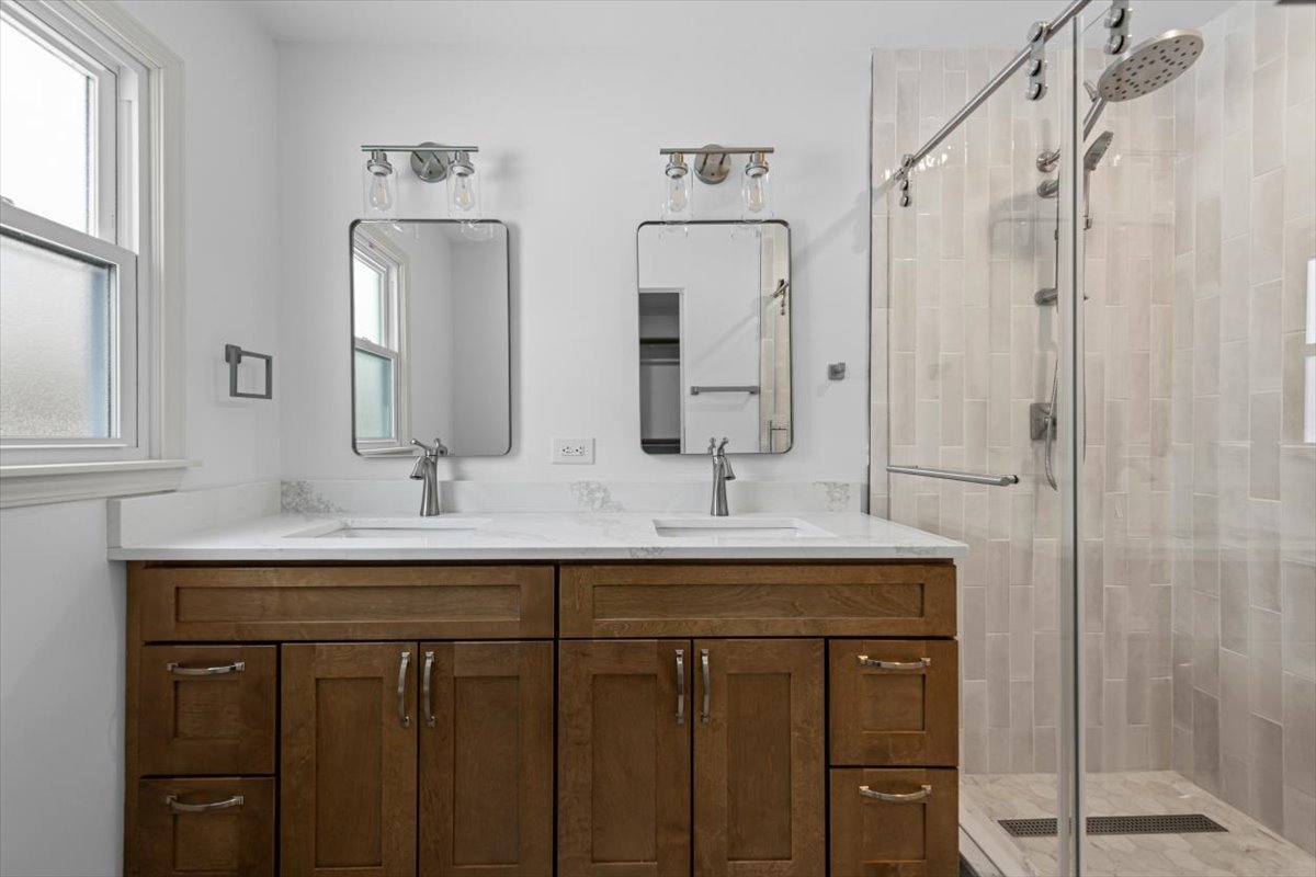 2527 Checker Road Long Grove, IL 60047 - Photo 23 of 32 a bathroom with double sink and a mirror