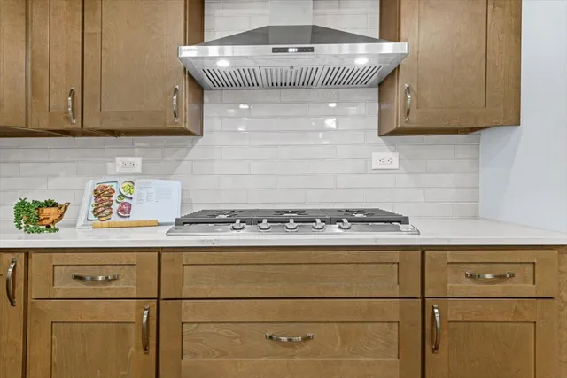 a kitchen with a stove and cabinets