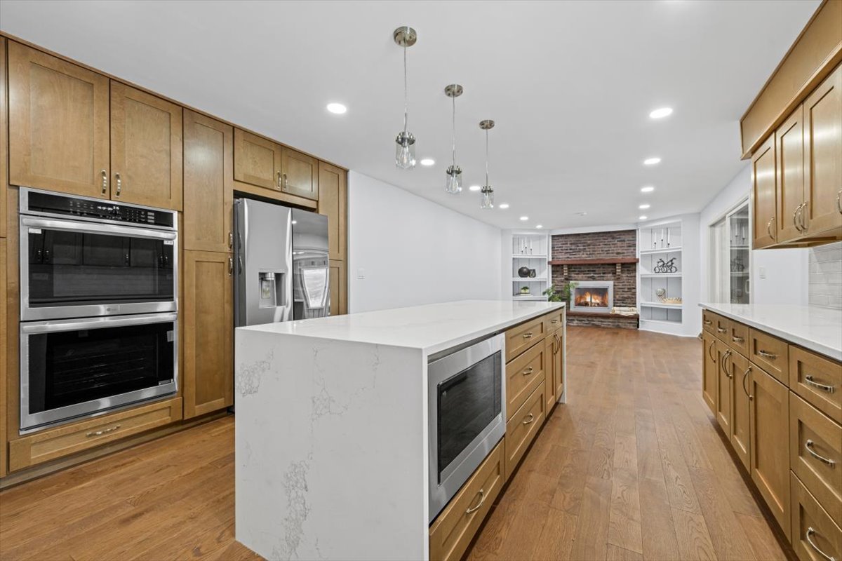 2527 Checker Road Long Grove, IL 60047 - Photo 8 of 32 a kitchen with stainless steel appliances kitchen island granite countertop a stove and a sink