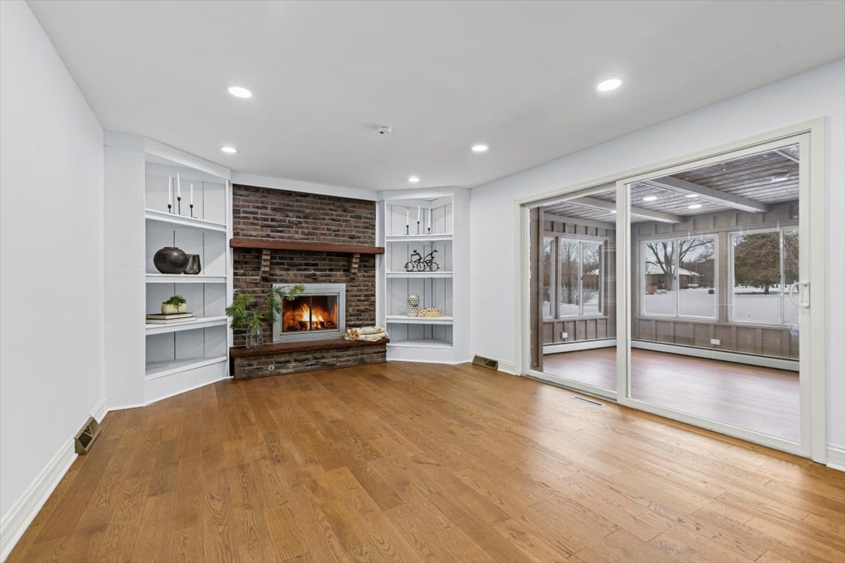 2527 Checker Road Long Grove, IL 60047 - Photo 10 of 32 a view of an empty room with a fireplace and a window
