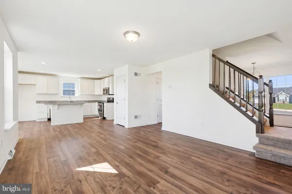 a view of kitchen with wooden floor and electronic appliances