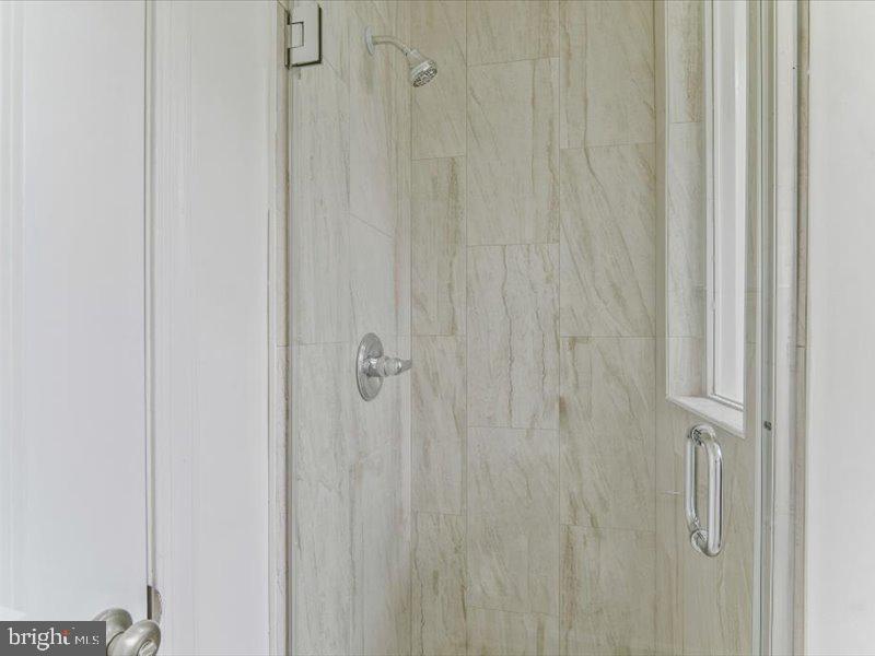 1200 D Street Northeast Washington, DC 20002 - Photo 24 of 47 Sleek, modern shower with elegant tiles.