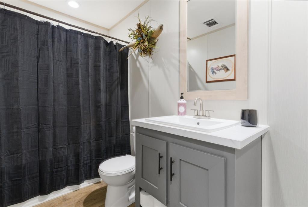 8792 Highway 67 Saltillo, TX 75478 - Photo 35 of 40 a bathroom with a sink toilet and shower