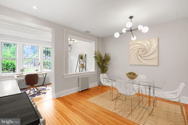 a view of a hallway with workspace and a window