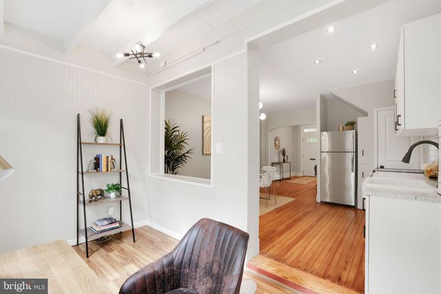 a table and chairs in a room next to a window