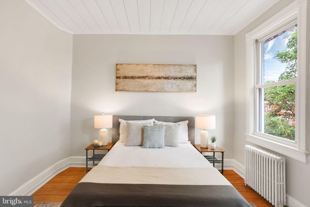 a view of backyard with outdoor seating and plants