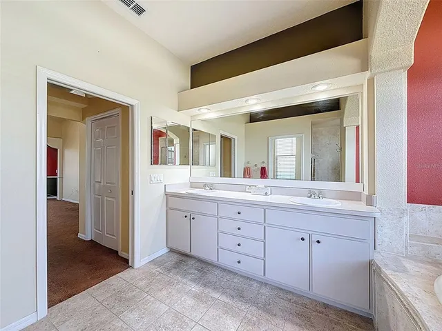 a spacious bathroom with a granite countertop sink a mirror and a