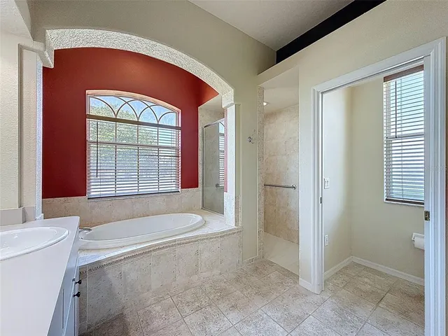a bathroom with a bathtub and a shower