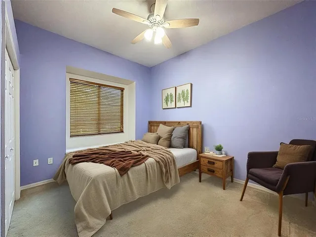 a bedroom with a bed and a couch