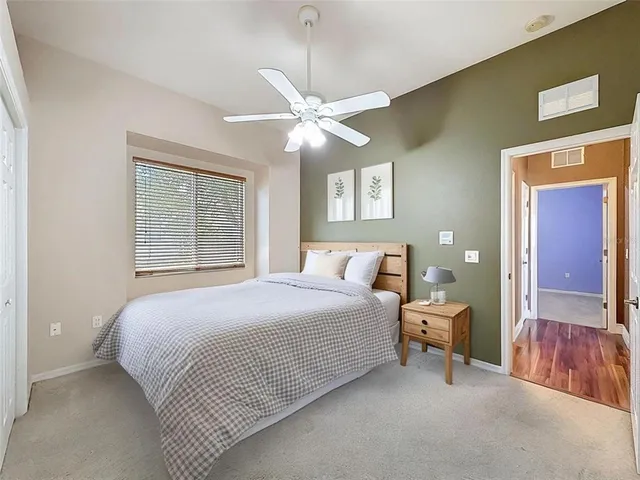 a bedroom with bed and a chandelier