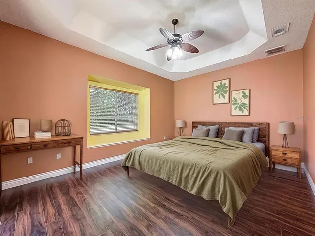 a spacious bedroom with a bed and a desk