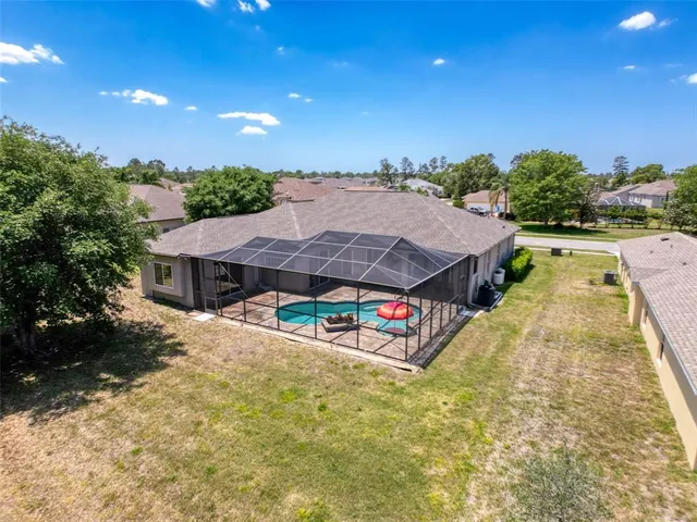 a view of a house with swimming pool and sitting area